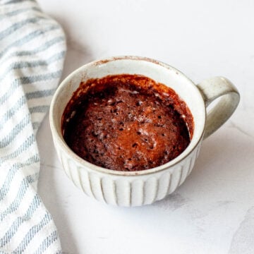 Close up image of a Chocolate Mug Cake, in a grey mug.