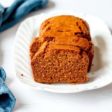 Close up image of a Gingerbread Loaf Cake on a white dish.