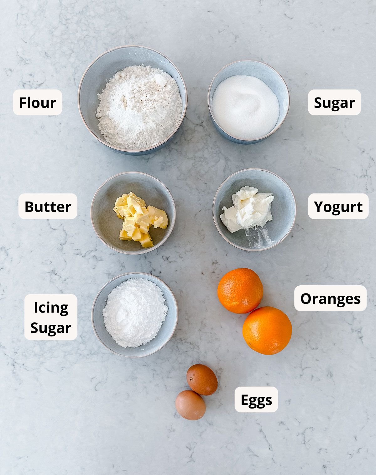 A collection of ingredients needed to make an orange cake.